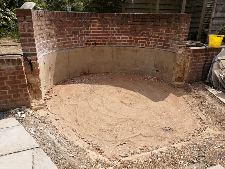 Pond structure removed, preserving the round brick work, surface prepared